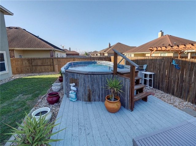 wooden terrace with a lawn and a swimming pool