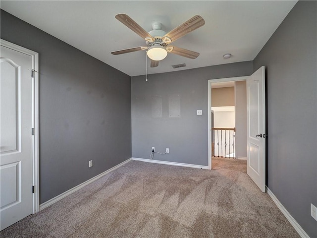 unfurnished bedroom with ceiling fan and light colored carpet