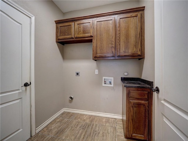 laundry area featuring gas dryer hookup, hookup for a washing machine, cabinets, and hookup for an electric dryer