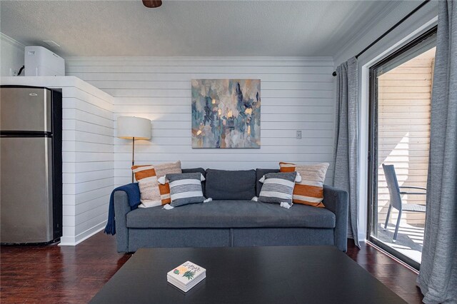 3938 Surfside Blvd Unit 3116, Corpus Christi, TX 78402 - living area featuring ornamental molding, wood finished floors, a textured ceiling, and wooden walls