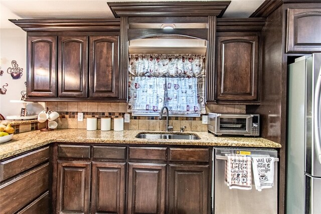 4009 Rooney Dr, Corpus Christi, TX 78413 - kitchen featuring appliances with stainless steel finishes, a sink, dark brown cabinets, and light stone counters
