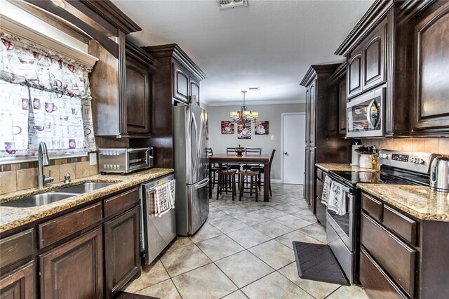4009 Rooney Dr, Corpus Christi, TX 78413 - kitchen featuring stainless steel appliances, a sink, a chandelier, dark brown cabinets, and light tile patterned flooring