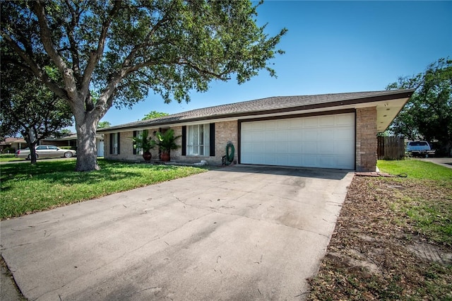 4009 Rooney Dr, Corpus Christi, TX 78413 - single story home with an attached garage, a front lawn, brick siding, and concrete driveway