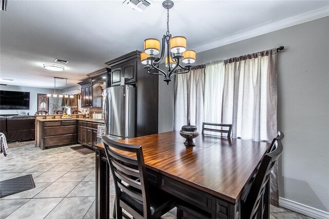4009 Rooney Dr, Corpus Christi, TX 78413 - dining space featuring a chandelier, plenty of natural light, light tile patterned flooring, baseboards, and ornamental molding