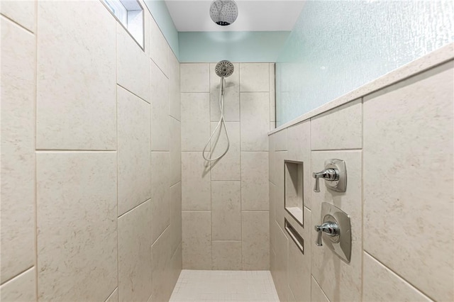 bathroom with a tile shower