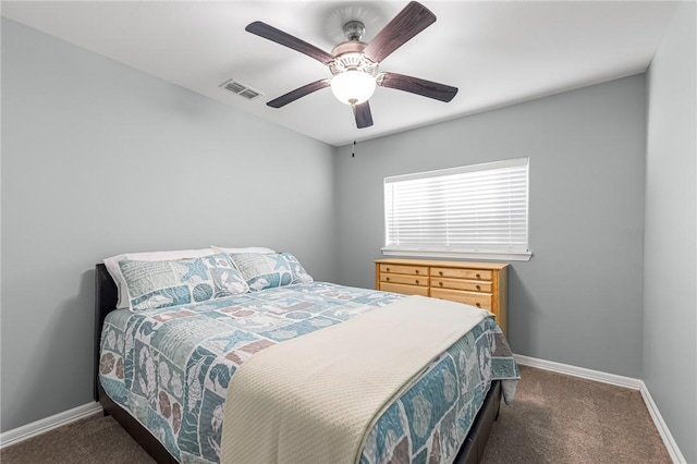 carpeted bedroom with visible vents, a ceiling fan, and baseboards