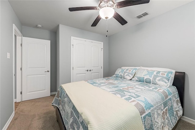 carpeted bedroom featuring a closet, visible vents, ceiling fan, and baseboards