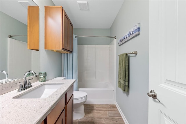 full bath featuring vanity, wood finished floors, visible vents, tub / shower combination, and toilet