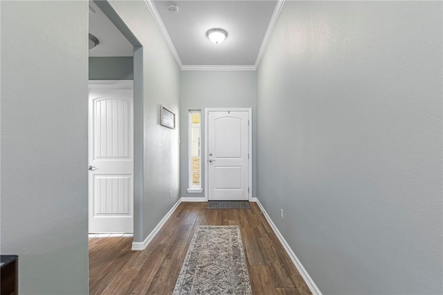 entryway featuring baseboards, wood finished floors, and crown molding