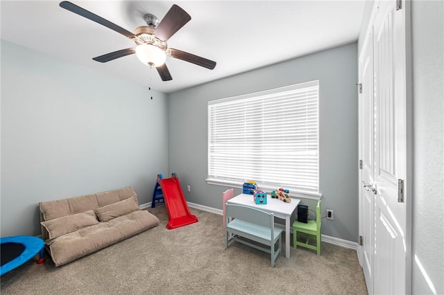 rec room with baseboards, a ceiling fan, and carpet flooring