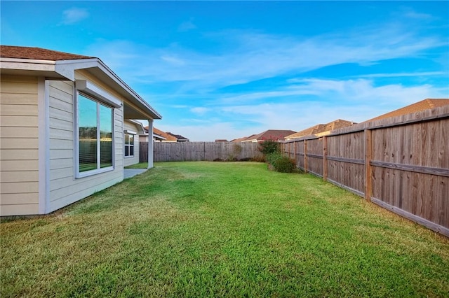 view of yard with a fenced backyard