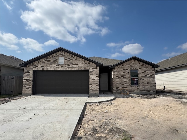 2689 Westeros St, Corpus Christi, TX 78415 - view of front of home with a shingled roof, a garage, concrete driveway, and brick siding