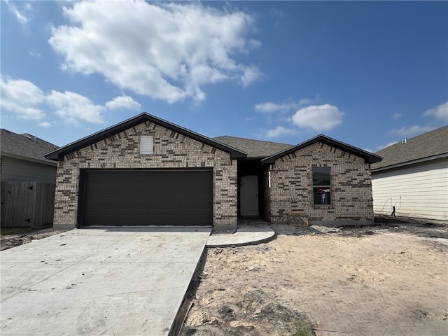 view of front of house with a garage, concrete driveway, and brick siding