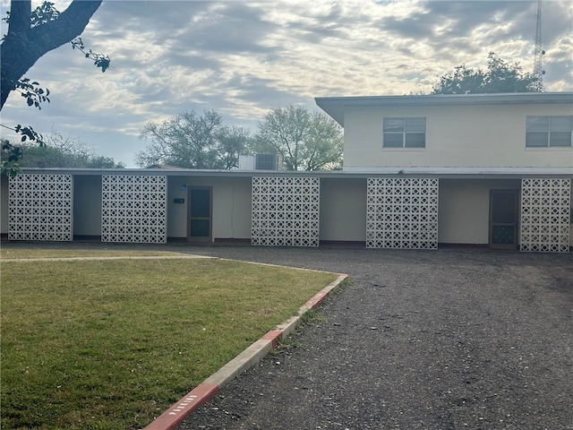 rear view of property featuring a yard