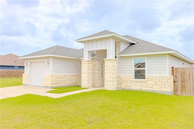1501 Days End Dr, Corpus Christi, TX 78417 - view of front facade with stone siding, concrete driveway, a shingled roof, an attached garage, and board and batten siding