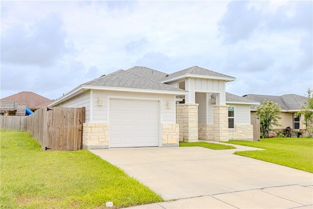 1501 Days End Dr, Corpus Christi, TX 78417 - prairie-style home with a garage, driveway, stone siding, a shingled roof, and board and batten siding