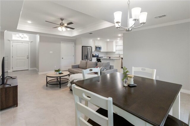 1501 Days End Dr, Corpus Christi, TX 78417 - dining area featuring a chandelier, ornamental molding, a tray ceiling, a ceiling fan, and recessed lighting