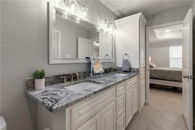 1501 Days End Dr, Corpus Christi, TX 78417 - full bathroom with ensuite bathroom, tile patterned flooring, double vanity, and a tray ceiling