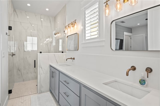 bathroom featuring vanity, a shower with door, and plenty of natural light