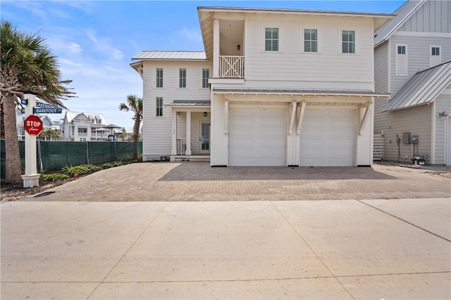 view of front of property with a garage and a balcony