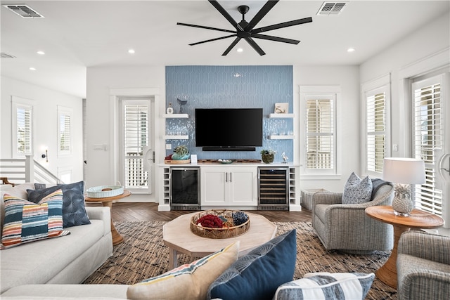 living room featuring beverage cooler, ceiling fan, and plenty of natural light