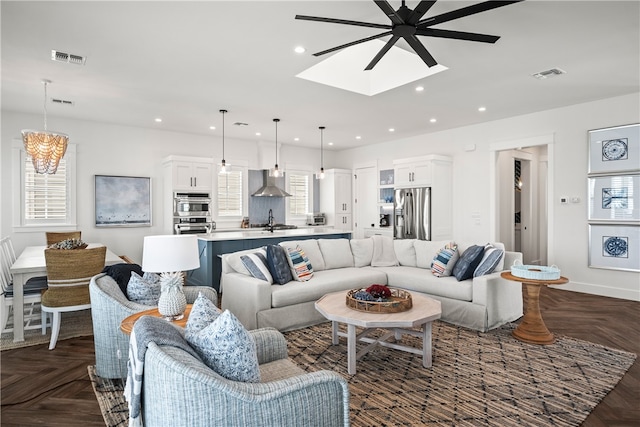 living room with sink, ceiling fan, a healthy amount of sunlight, and dark parquet flooring