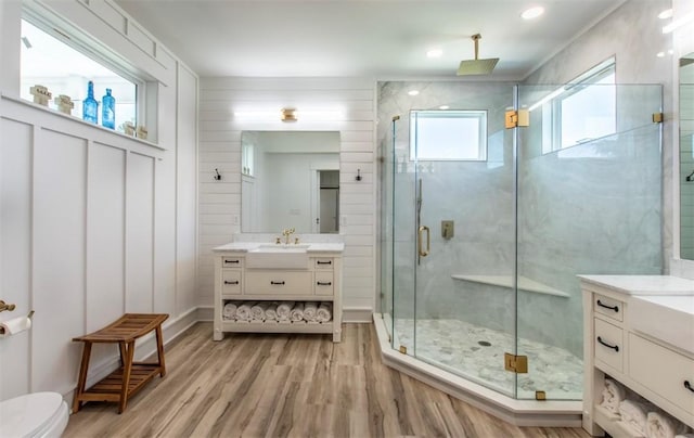 1227 S Magnolia St, Rockport, TX 78382 - bathroom with a shower stall, wood finished floors, vanity, and toilet