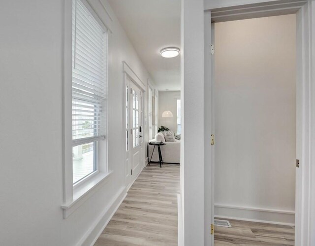 1227 S Magnolia St, Rockport, TX 78382 - hallway with visible vents, light wood-style flooring, and baseboards