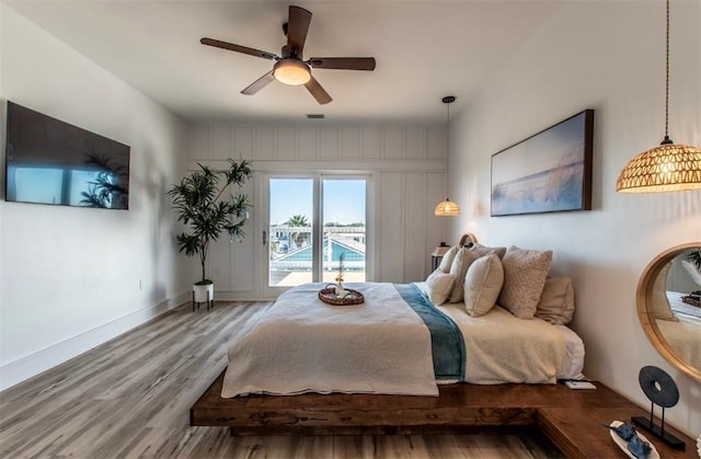 1227 S Magnolia St, Rockport, TX 78382 - bedroom with access to exterior, ceiling fan, wood finished floors, and baseboards