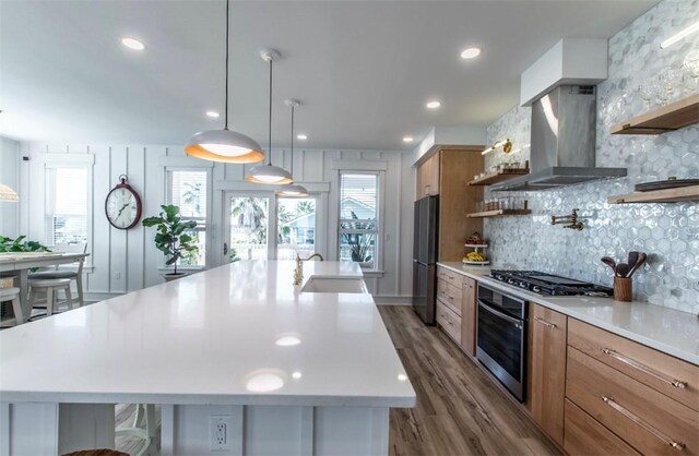 1227 S Magnolia St, Rockport, TX 78382 - kitchen featuring wall chimney exhaust hood, open shelves, light countertops, a sink, and stainless steel appliances