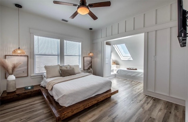 1227 S Magnolia St, Rockport, TX 78382 - bedroom with a skylight, wood finished floors, ceiling fan, and visible vents