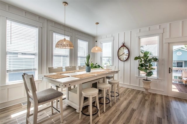 1227 S Magnolia St, Rockport, TX 78382 - dining room featuring a decorative wall and light wood-style flooring