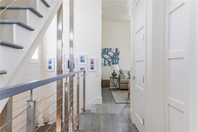 hall featuring wooden ceiling and baseboards