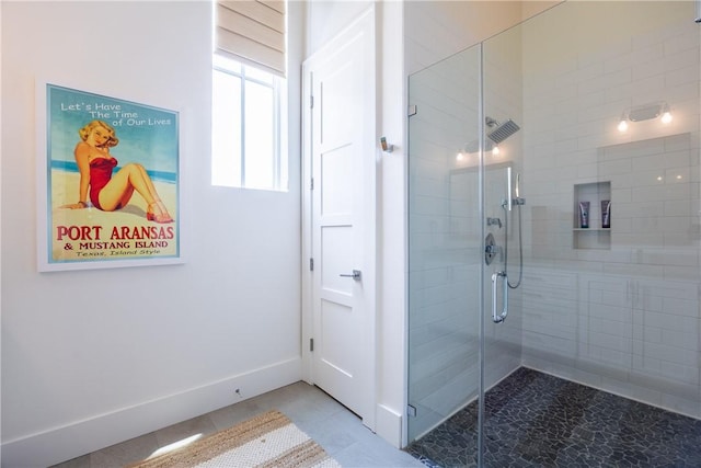 full bathroom featuring a stall shower, baseboards, and tile patterned floors