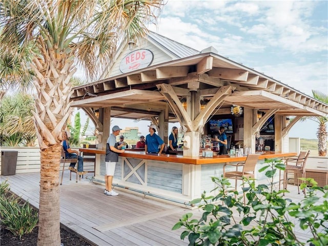 wooden deck featuring outdoor dry bar and a gazebo