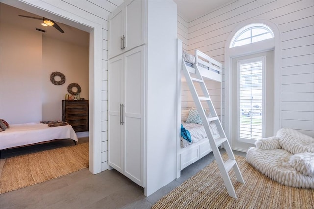 bedroom featuring wood walls