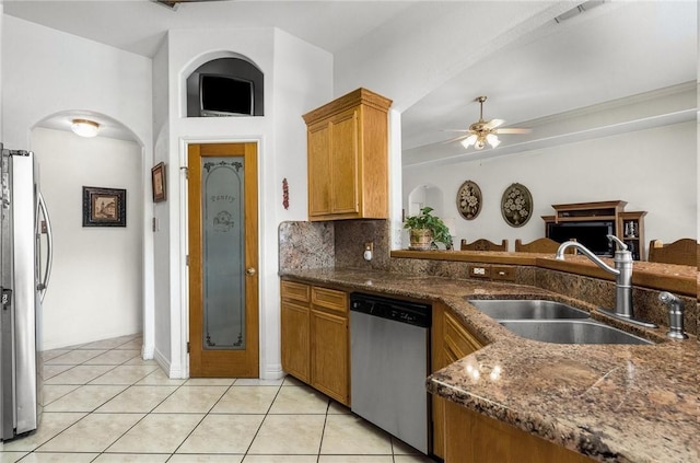 15426 Cuttysark St, Corpus Christi, TX 78418 - kitchen with stainless steel appliances, a ceiling fan, light tile patterned floors, and brown cabinets