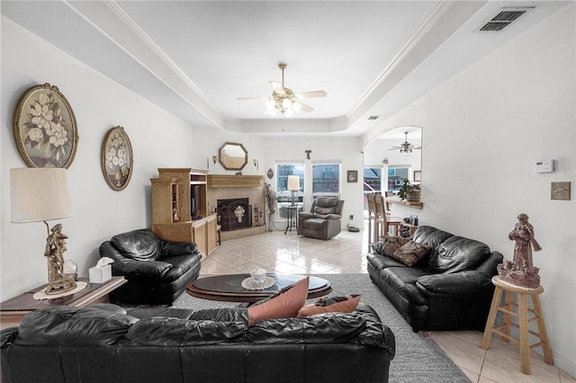 15426 Cuttysark St, Corpus Christi, TX 78418 - living area featuring ceiling fan, light tile patterned flooring, a tile fireplace, and a raised ceiling