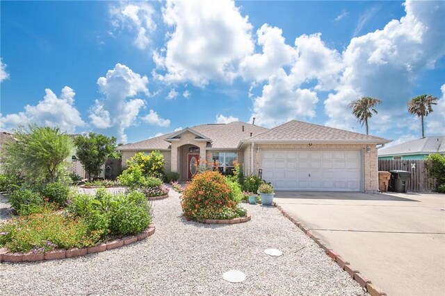 15426 Cuttysark St, Corpus Christi, TX 78418 - ranch-style home featuring brick siding, driveway, an attached garage, and roof with shingles