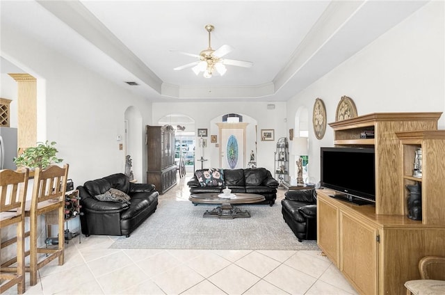 15426 Cuttysark St, Corpus Christi, TX 78418 - living room featuring arched walkways, a ceiling fan, light tile patterned floors, and a raised ceiling