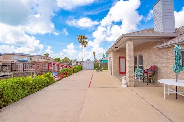 15426 Cuttysark St, Corpus Christi, TX 78418 - view of patio / terrace featuring a storage unit and a residential view