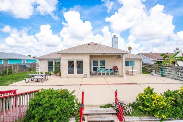 15426 Cuttysark St, Corpus Christi, TX 78418 - back of property featuring a patio, a fenced backyard, and brick siding
