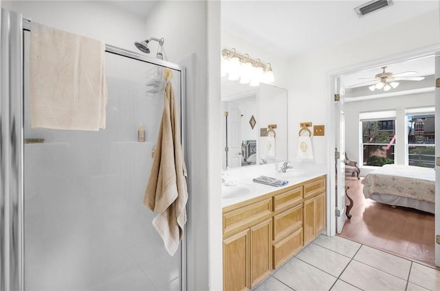 15426 Cuttysark St, Corpus Christi, TX 78418 - bathroom with a shower stall, tile patterned floors, double vanity, a ceiling fan, and ensuite bath