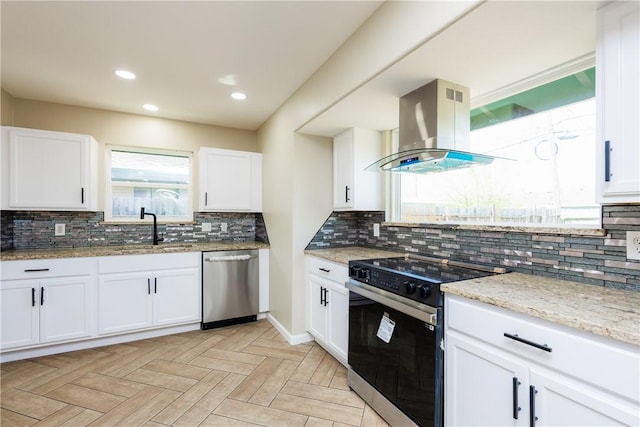 kitchen featuring light stone countertops, island exhaust hood, a sink, electric range oven, and stainless steel dishwasher