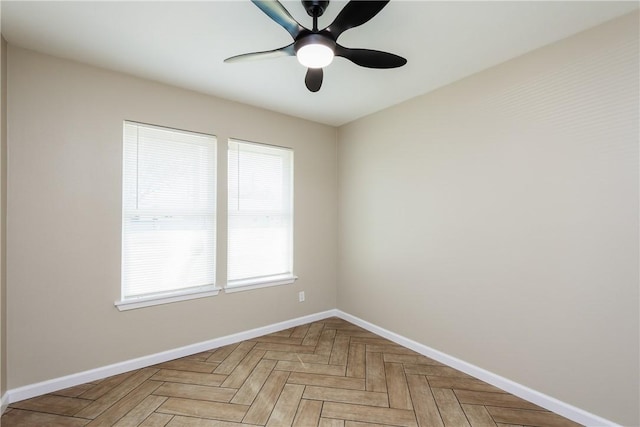 spare room featuring baseboards and a ceiling fan