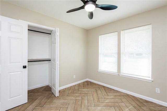 unfurnished bedroom with a closet, baseboards, and a ceiling fan