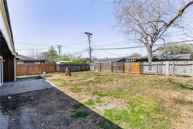 view of yard featuring a patio area and a fenced backyard