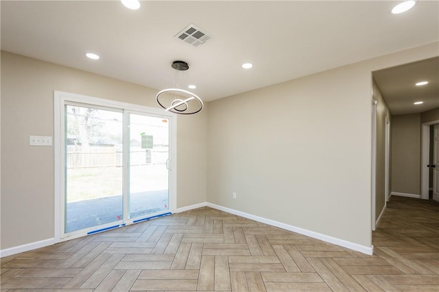 spare room featuring recessed lighting, visible vents, and baseboards