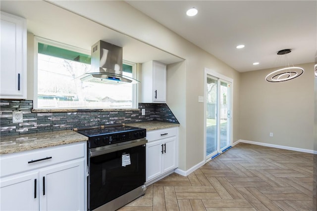 kitchen with tasteful backsplash, black range with electric stovetop, wall chimney exhaust hood, and white cabinetry