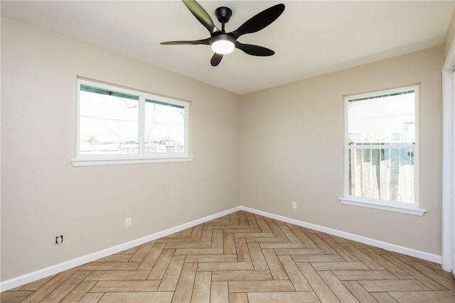 empty room featuring a healthy amount of sunlight and baseboards